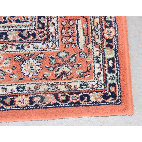 212 - 20th Century salmon ground rug approx. 162cm x 125cm