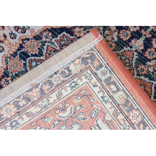 212 - 20th Century salmon ground rug approx. 162cm x 125cm