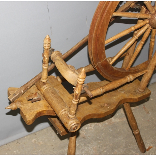 123 - A vintage wooden spinning wheel, approx 97cm wide