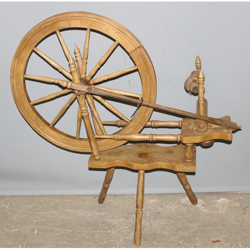 123 - A vintage wooden spinning wheel, approx 97cm wide