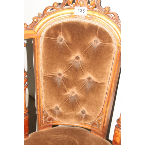 136 - A Victorian Mahogany nursing chair with carved frame, button back and ceramic castors