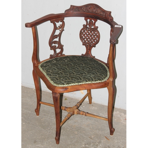 139 - A 19th century corner chair with carved frame and scalloped upholstery