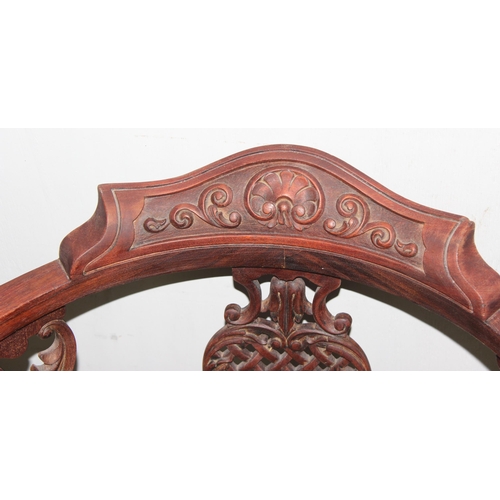 139 - A 19th century corner chair with carved frame and scalloped upholstery