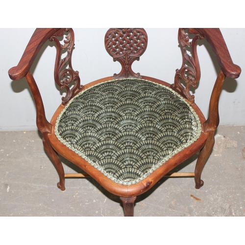 139 - A 19th century corner chair with carved frame and scalloped upholstery