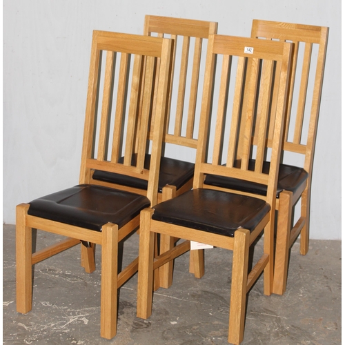 142 - A set of 4 good quality modern light oak and leather dining chairs