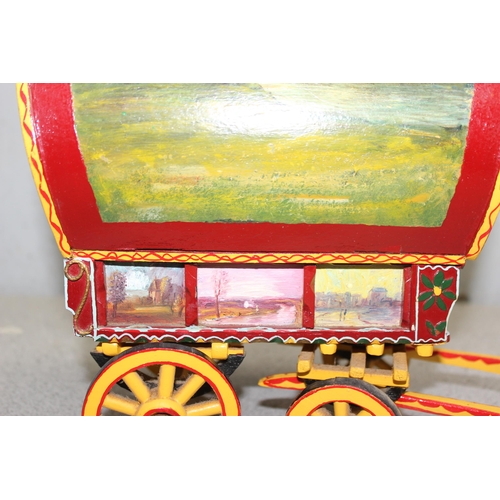 1562 - A vintage hand painted model of a wooden gypsy caravan, approx 34cm long