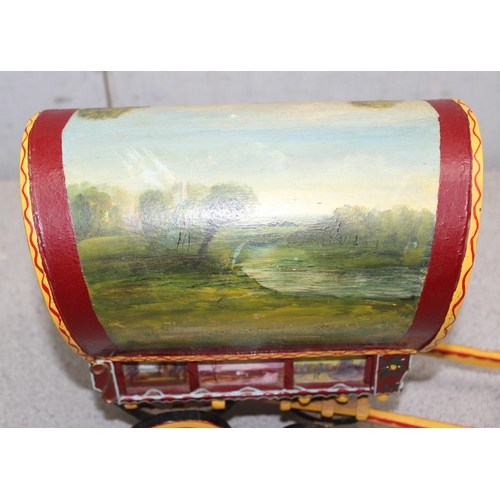 1562 - A vintage hand painted model of a wooden gypsy caravan, approx 34cm long