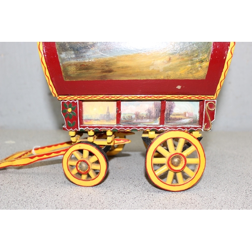 1562 - A vintage hand painted model of a wooden gypsy caravan, approx 34cm long