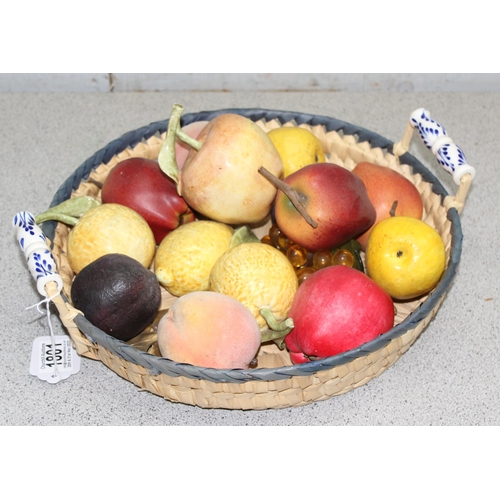 1801 - A basket containing various ceramic and other faux fruits