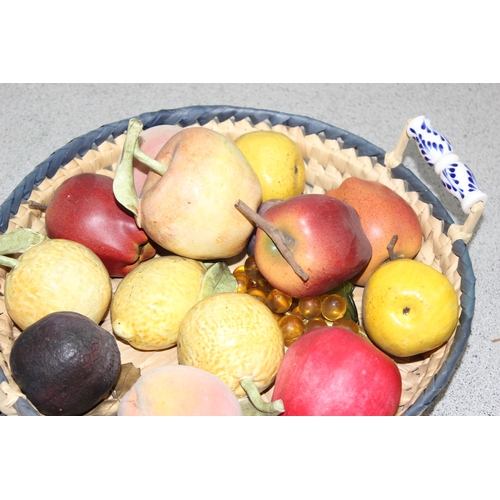 1801 - A basket containing various ceramic and other faux fruits