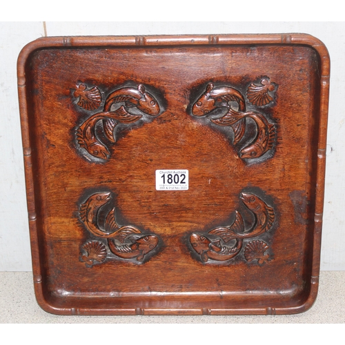 1802 - A vintage Oriental carved wooden tray depicting fish, approx 34cm square