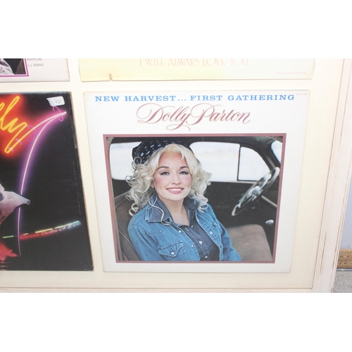 480 - A framed display of 4 Dolly Parton vinyl record sleeves, unchecked if records are present, approx 78... 