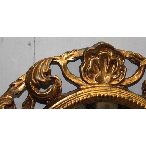 481 - A large oval shaped Rococo style gilt framed mirror with acanthus scrolls, approx 79cm x 58cm