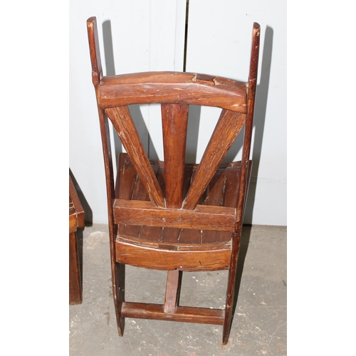 153 - A pair of unusual wooden chairs formed from vintage cartwheels