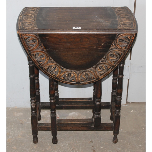 154 - A small vintage oak drop leaf table with carved border, approx 100cm wide x 60cm deep x 74cm tall