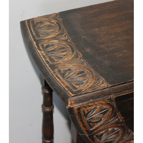 154 - A small vintage oak drop leaf table with carved border, approx 100cm wide x 60cm deep x 74cm tall