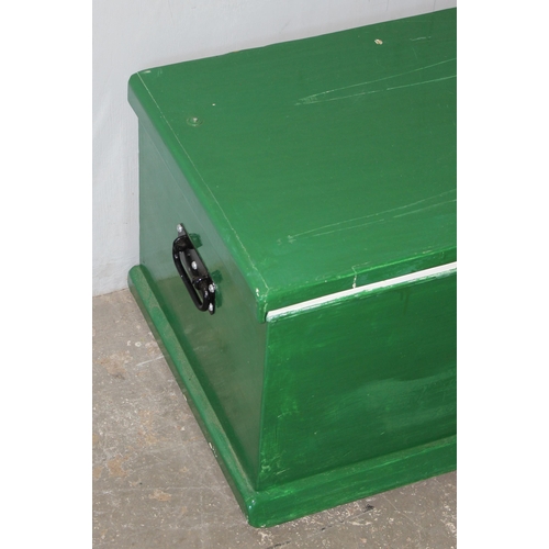 158 - A vintage green painted pine trunk with iron handles, approx 94cm wide x 45cm deep x 41cm tall