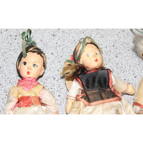 1504 - Vintage hand painted pottery dolls with articulated limbs in traditional eastern European dress, eac... 