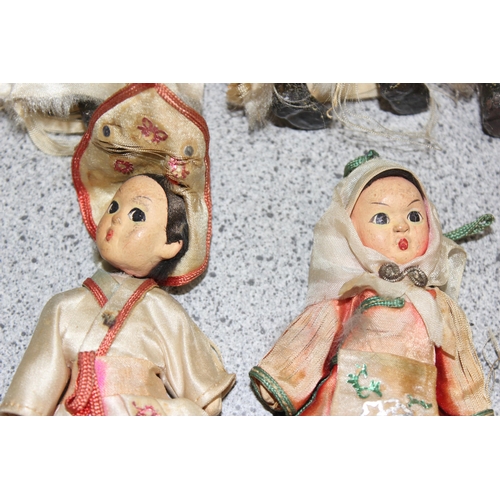 1504 - Vintage hand painted pottery dolls with articulated limbs in traditional eastern European dress, eac... 