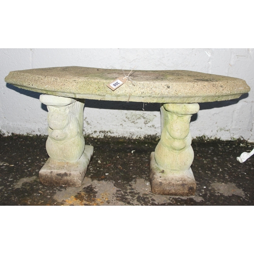 308 - A weathered concrete garden bench with curved top and squirrel shaped supports, approx 100cm wide