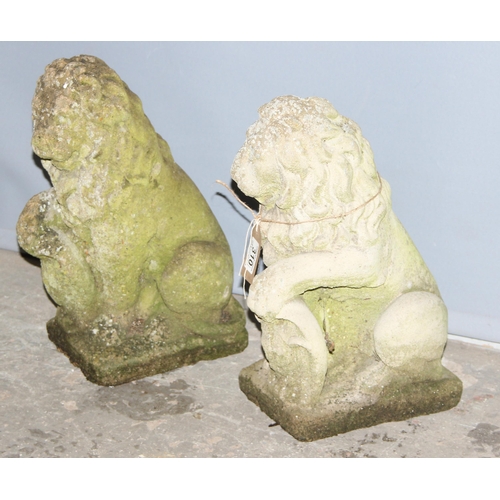 310 - A pair of weathered concrete garden lion statues, each approx 42cm tall