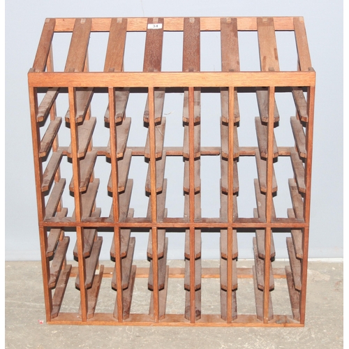 34 - A wooden wine bottle rack, capacity for 56 bottles, approx 70cm wide x 32cm deep x 79cm tall