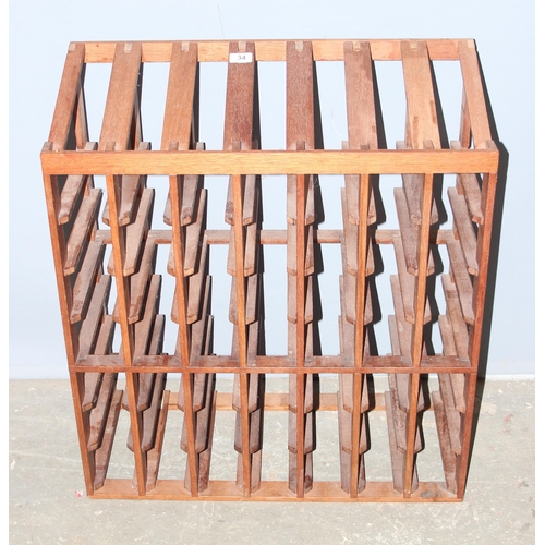 34 - A wooden wine bottle rack, capacity for 56 bottles, approx 70cm wide x 32cm deep x 79cm tall