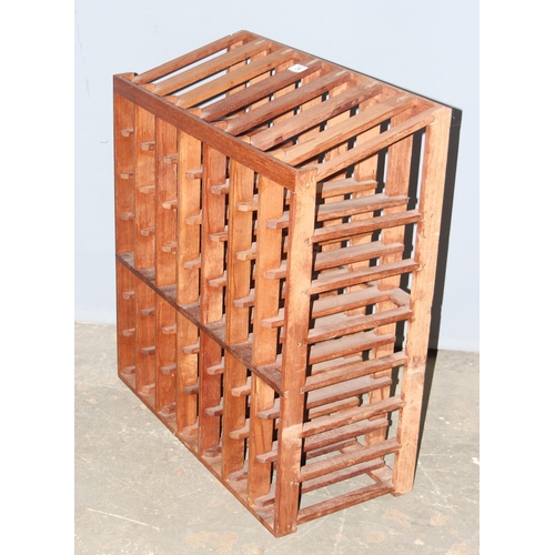 34 - A wooden wine bottle rack, capacity for 56 bottles, approx 70cm wide x 32cm deep x 79cm tall