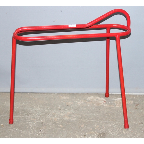 67 - Small red painted metal saddle rack