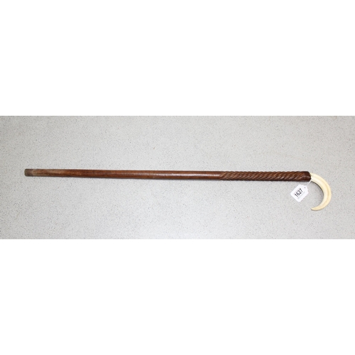 1627 - Carved wooden walking cane with Warthog tooth handle