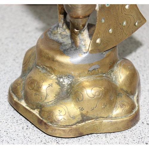 1630 - S.E Asian brass deity, stands approx. 24cm