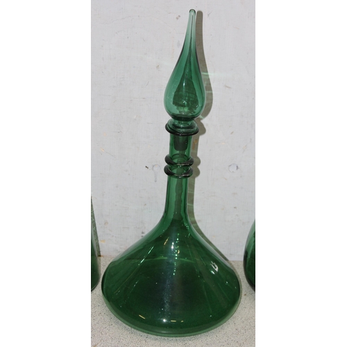 1708 - 8 assorted vintage green glass decanters, carafes, bottles etc