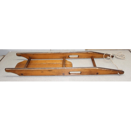 1568 - Vintage wooden child's sleigh by Triang, approx 106cm long