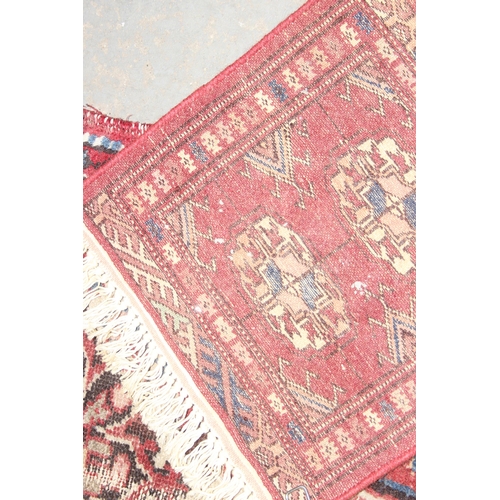 220 - 2 vintage rugs both of red ground, the largest approx 84cm x 56cm