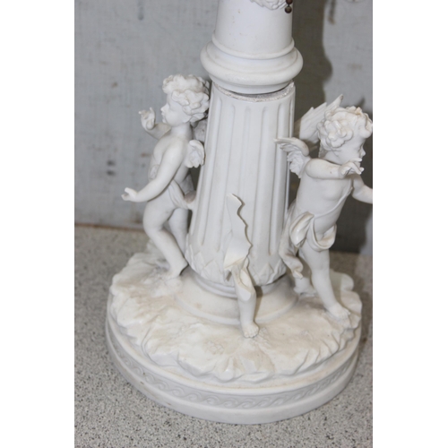 252 - A pair of antique Parianware porcelain candlesticks later converted into lamps, decorated with cheru... 