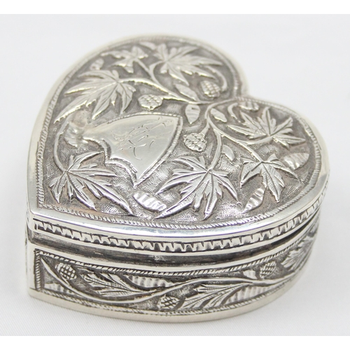 1080 - An antique Anglo-Indian heart shaped silver trinket box with embossed decoration, seemingly unmarked... 