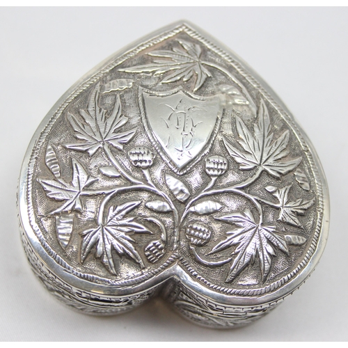 1080 - An antique Anglo-Indian heart shaped silver trinket box with embossed decoration, seemingly unmarked... 