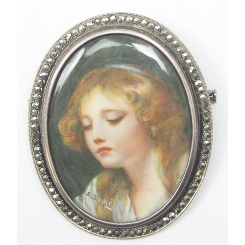 2443 - A vintage hand painted portrait miniature brooch in silver marcasite mount, the painting depicting a... 