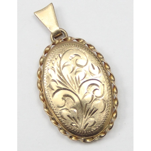 2446 - A vintage 9ct gold pendant locket with engraved decoration and rope twist border, Birmingham 1982, a... 