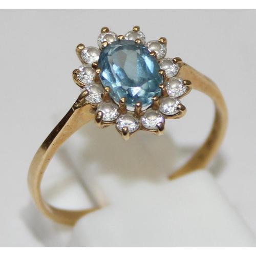 2450 - An 18ct gold floral set ring, a central Aquamarine surrounded by white stones, marked 750 and XRF co... 