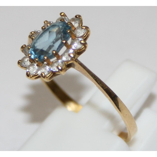 2450 - An 18ct gold floral set ring, a central Aquamarine surrounded by white stones, marked 750 and XRF co... 