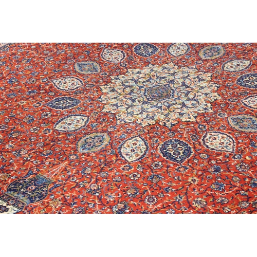 225 - An extremely large British made burnt orange ground rug, approx 275cm x 365cm