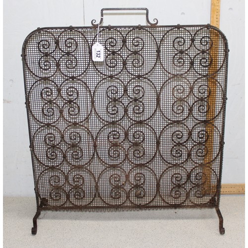 132 - A vintage wrought iron fire screen or spark guard, approx 63cm wide x 71cm tall