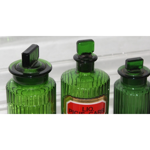 1732 - 4 vintage green glass apothecary bottles and a green glass eye bath (5)