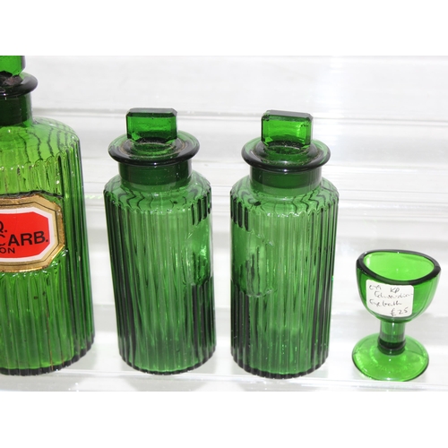 1732 - 4 vintage green glass apothecary bottles and a green glass eye bath (5)