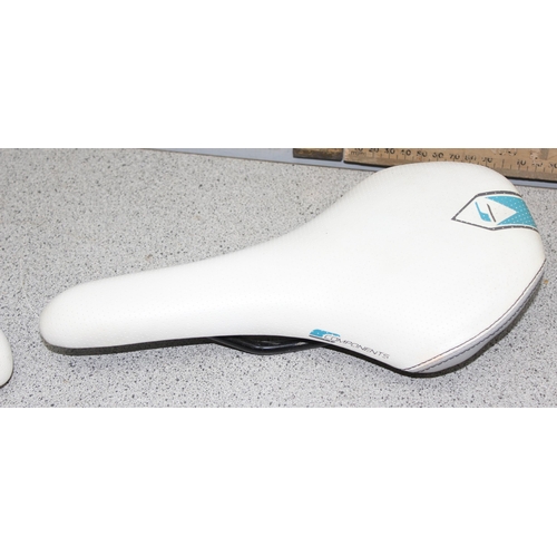 701 - 2 Components bicycle racing saddles & a bicycle rack