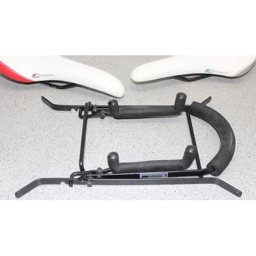 701 - 2 Components bicycle racing saddles & a bicycle rack