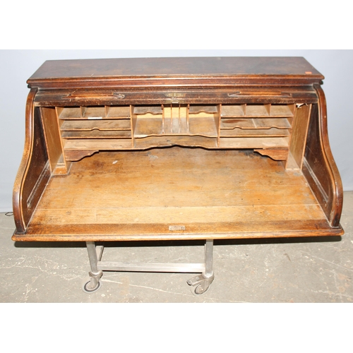 18 - An antique oak roll top desk with tambour front, approx 127cm wide x 76cm deep x 126cm tall