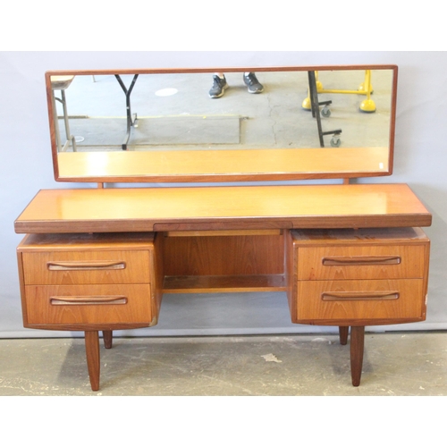 17 - A retro G-Plan tea dressing table with mirror and 4 drawers, approx 152cm wide x 46cm deep x 150cm t... 