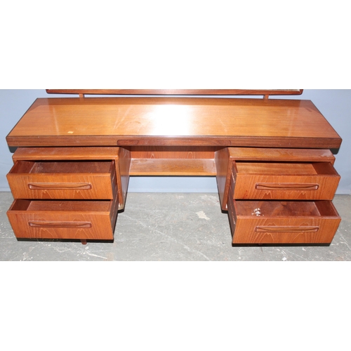 17 - A retro G-Plan tea dressing table with mirror and 4 drawers, approx 152cm wide x 46cm deep x 150cm t... 